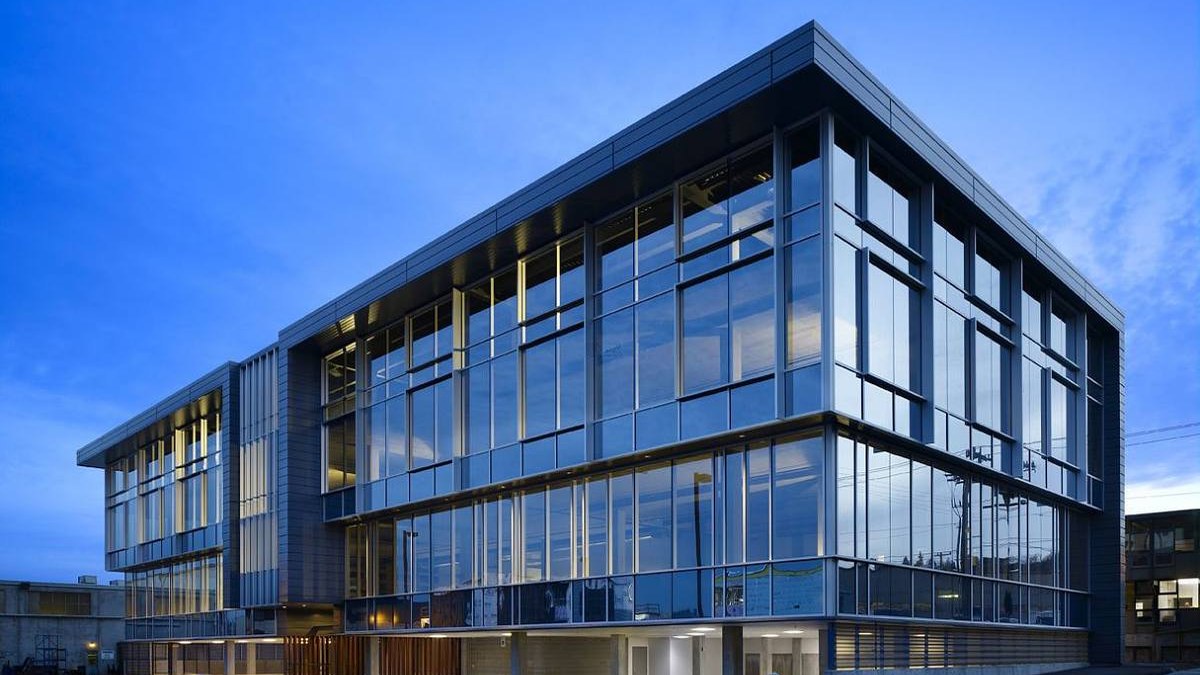 Office building with a glass curtain wall at dusk