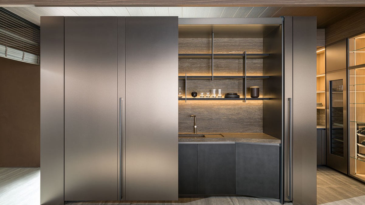 Tall kitchen storage cabinets with an open illuminated shelving area